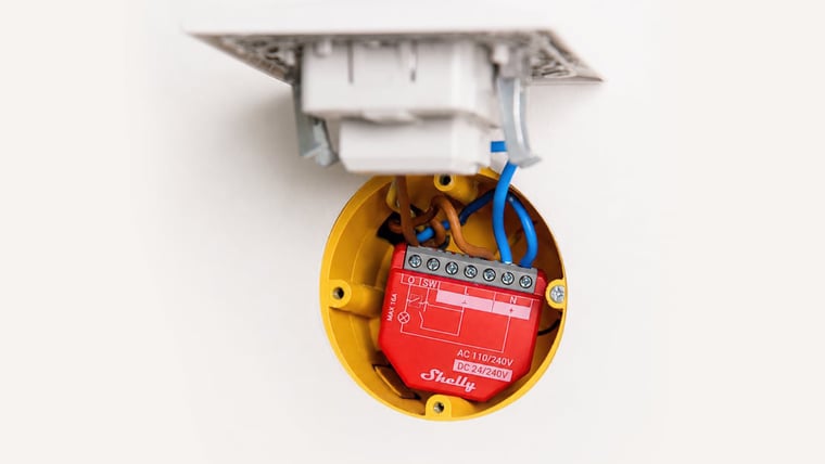 Shelly 1PM Gen4 Smart Relay wired into a wall box behind a socket plate