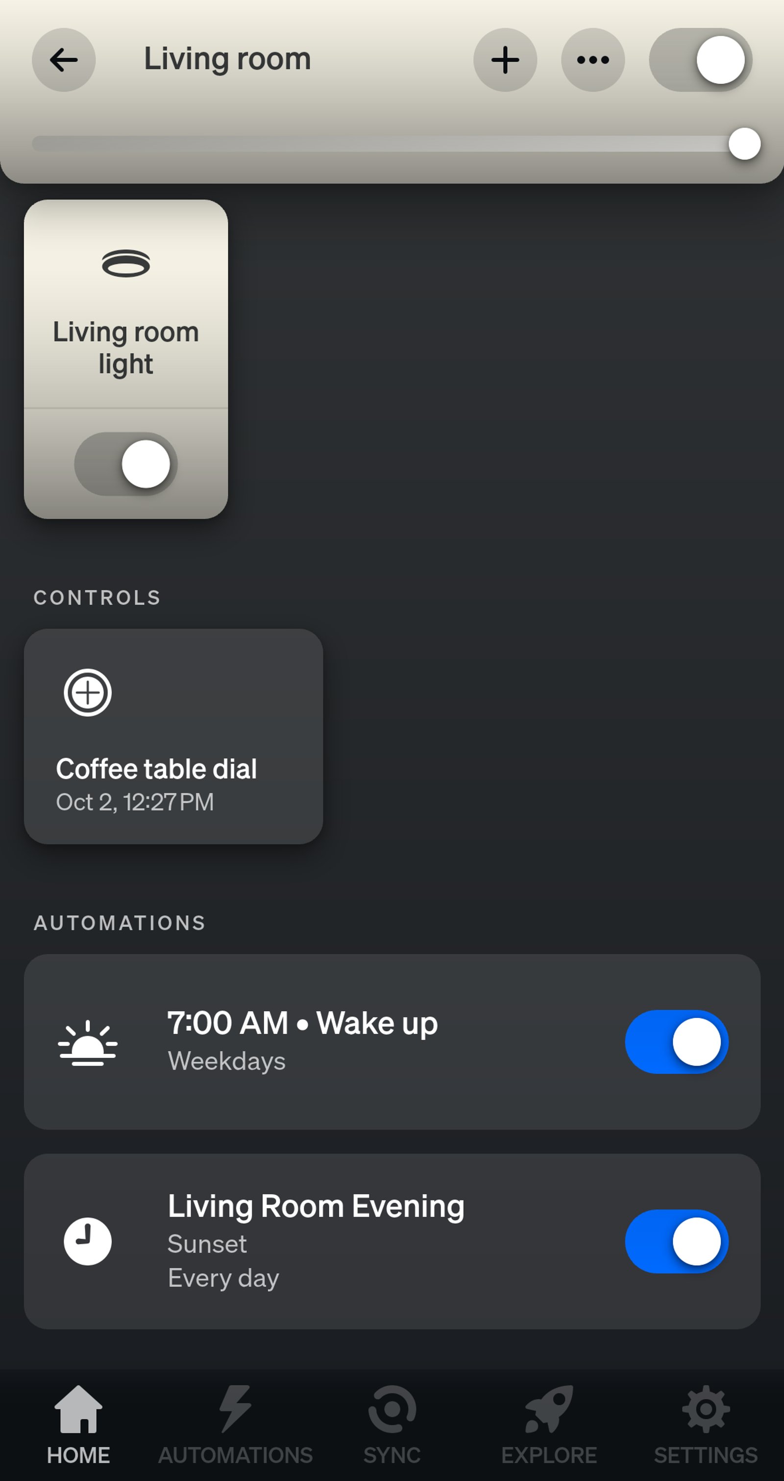 Philips Hue app Living room page showing a light named Living room light, a Tap dial switch, a 7:00 AM weekday Wake up and the Living Room Evening schedule at sunset.