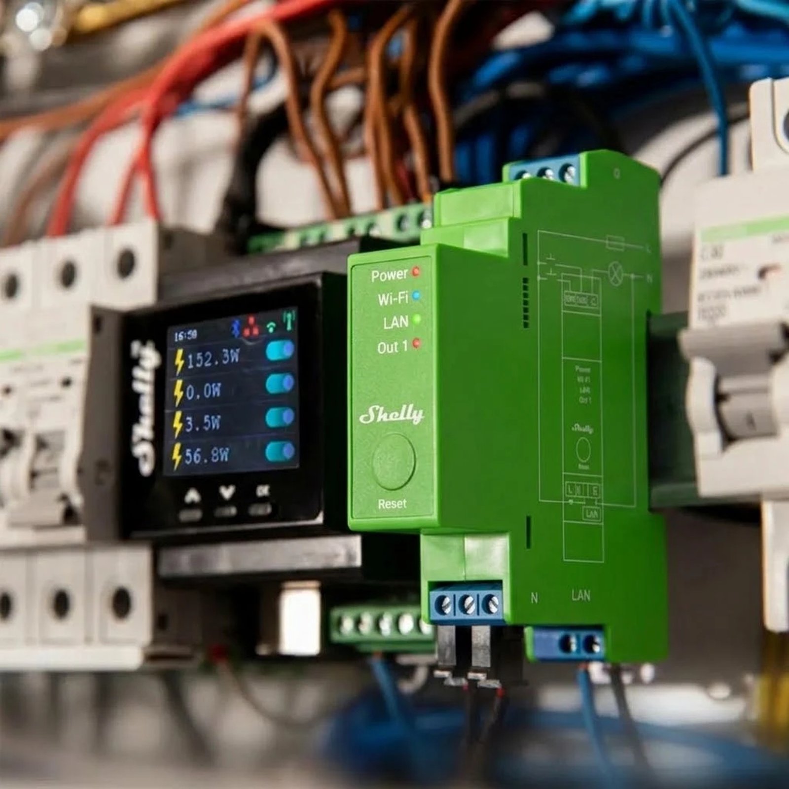 A green Shelly Pro module on the DIN rail in a switchboard, beside the circuit breakers