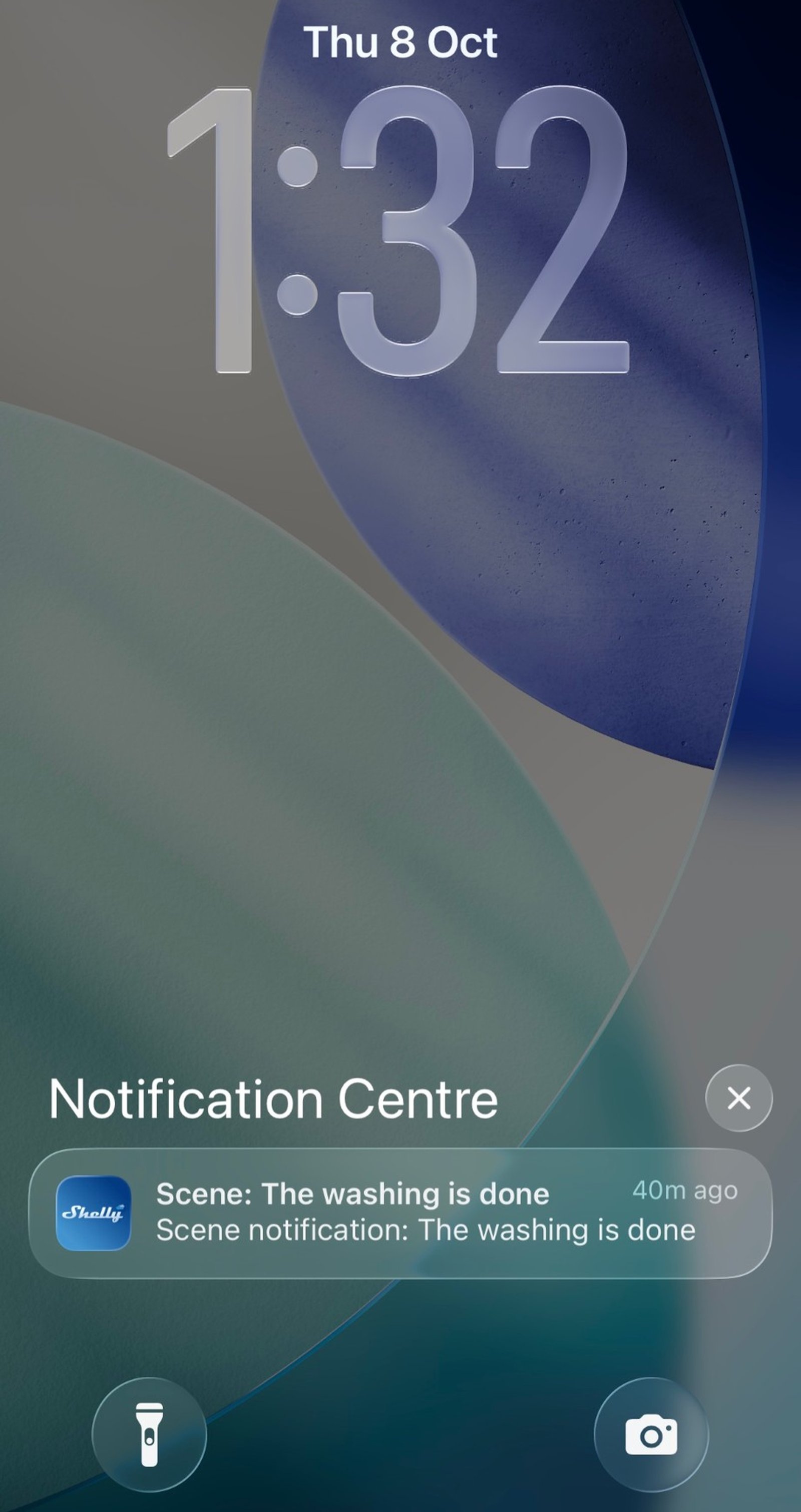 iPhone lock screen showing a Shelly notification that reads The washing is done.