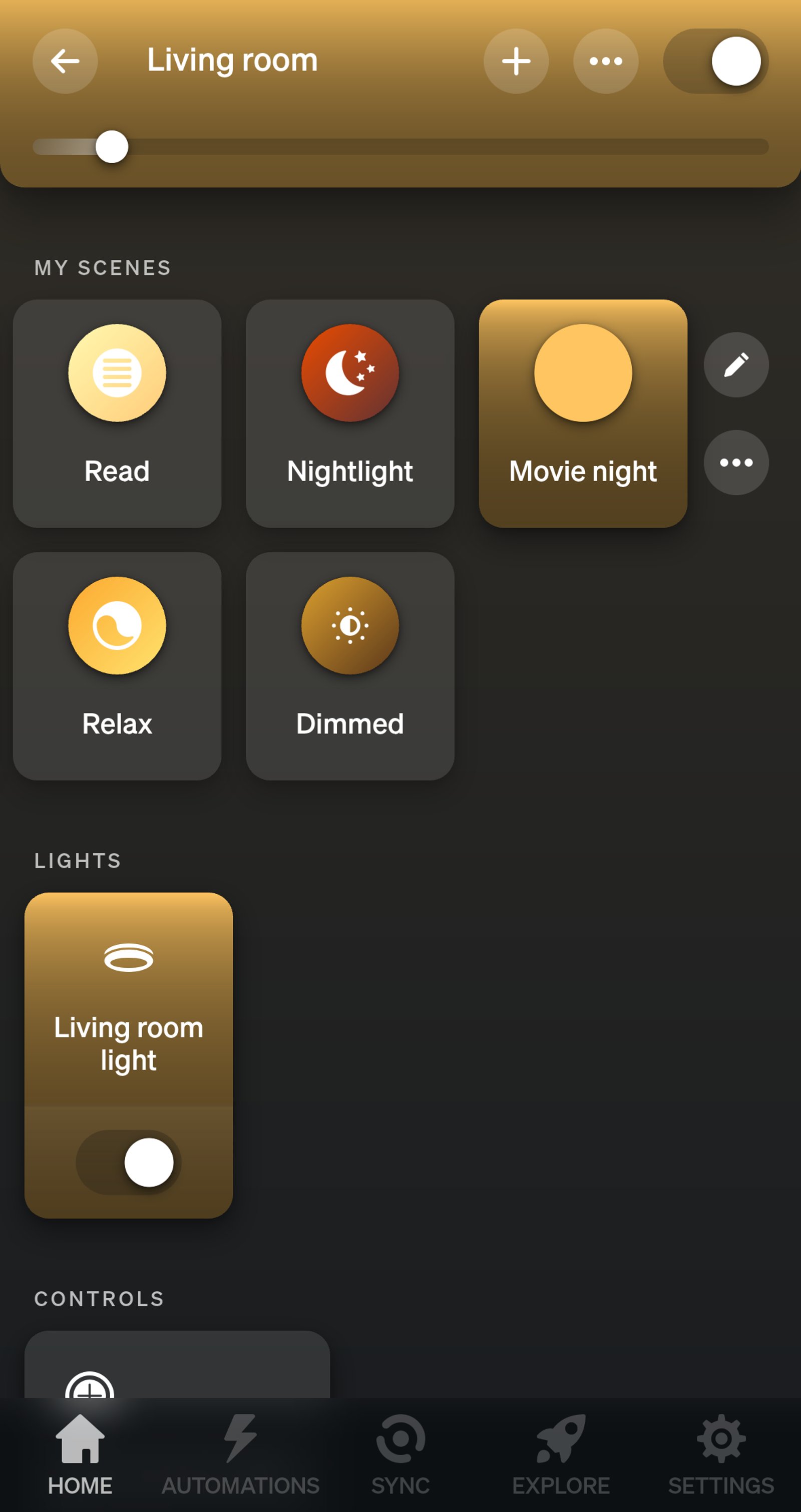 Philips Hue app Living room page with the Movie night scene on and the brightness slider low.