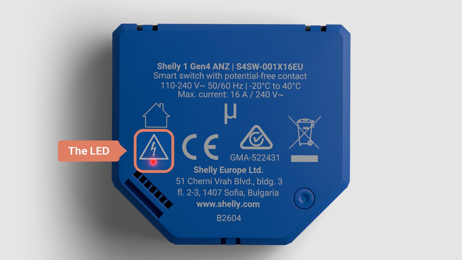 The back of a Shelly 1 Gen4 with its red status LED lit just below the warning triangle